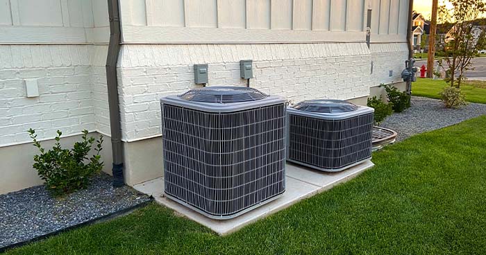 Image: two condensers outside a home. For great work, call JW for the best Beverly Hills Air Conditioner Repair.