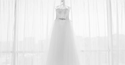 Image: a hanging wedding dress.