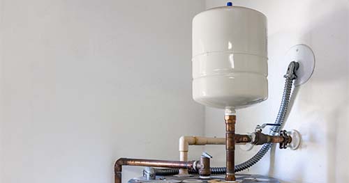 Image: an expansion tank on a standard water heater.