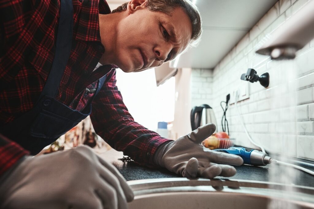 plumber inspecting sink
