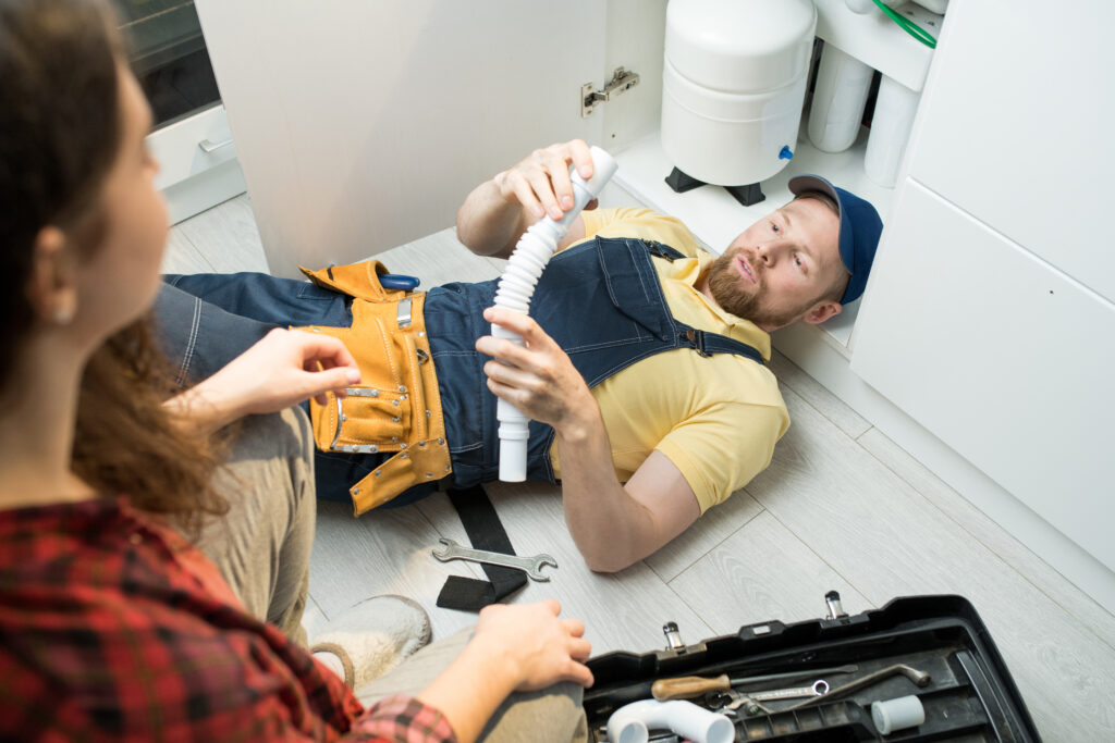  plumber changing trap under sink